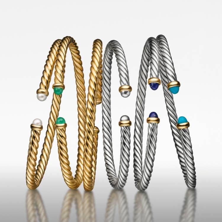 Six David Yurman Cable Flex bracelets in silver and gold.