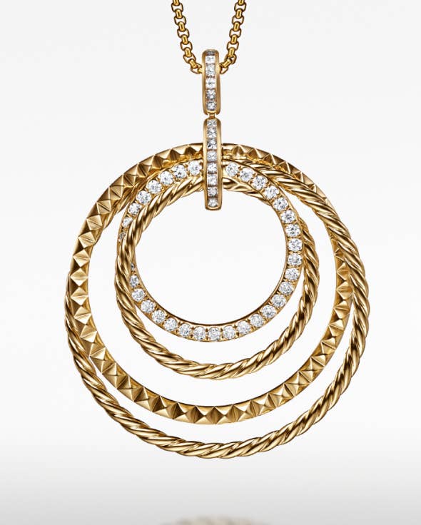 A David Yurman Crossover pendant in gold with diamonds.