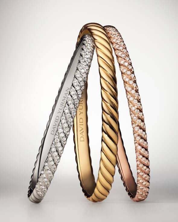 Three David Yurman Sculpted Cable bracelets.