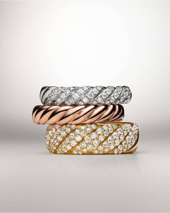 A David Yurman Sculpted Cable ring in gold with Diamond pave..