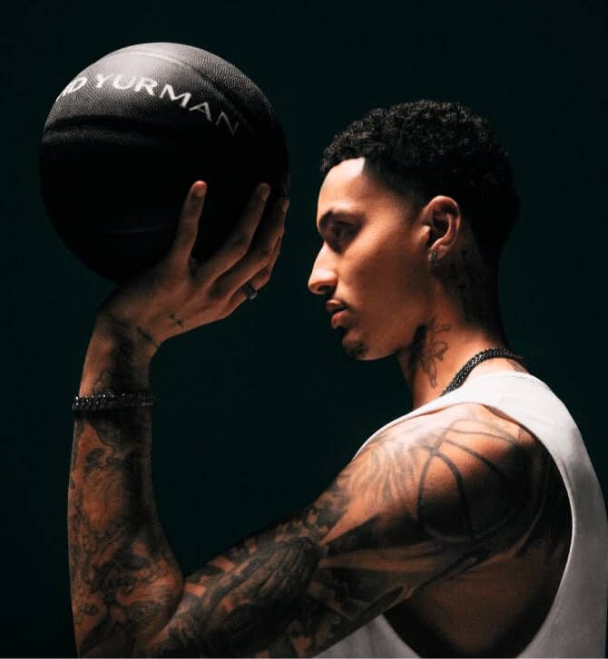 Kyle Kuzma holding a basketball.